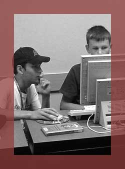 Program Evaluation: Student and instructor working at a computer.